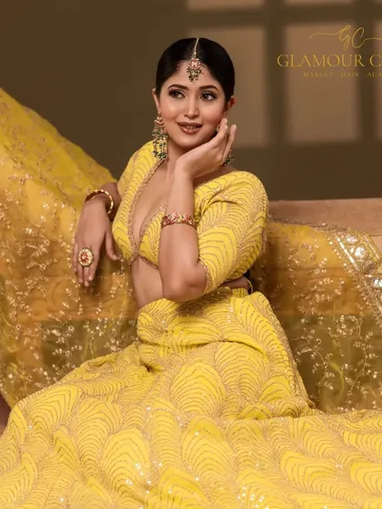 This portrait captures the vibrant energy of a Haldi or Mehendi look. The bright yellow lehenga and the model's joyful expression create a picture of celebration and happiness.