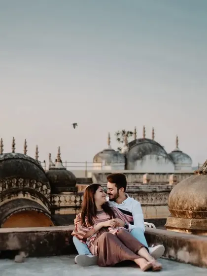 An intimate moment on the rooftop, with the couple lost in their own world against the backdrop of the city's historic domes.