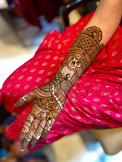 A side view of a bridal arm, showing how the design flows from the palm to the elbow with continuous, detailed patterns.