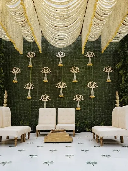 A frontal view of the mandap, showing the clean, symmetrical design and traditional brass elements.