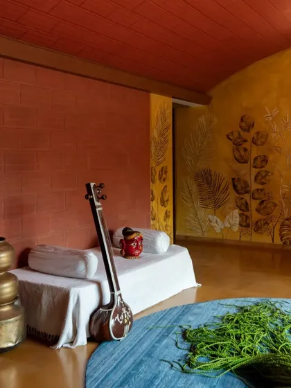 I love creating spaces that are vibrant and full of character. This room combines a vaulted terracotta ceiling, a warm Jaisalmer stone floor, and a yellow oxide wall with leaf imprints, creating an earthy and artistic sanctuary.