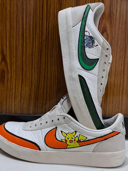 A pair of classic Nike sneakers transformed into wearable art. I hand-painted these with a custom Pokémon theme, featuring Pikachu on one shoe and Bulbasaur on the other, each integrated with the iconic swoosh.