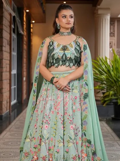 Here is the full view of the pastel green floral lehenga, showcasing its elegant silhouette and attached cape. It's a modern and sophisticated choice for any wedding function.