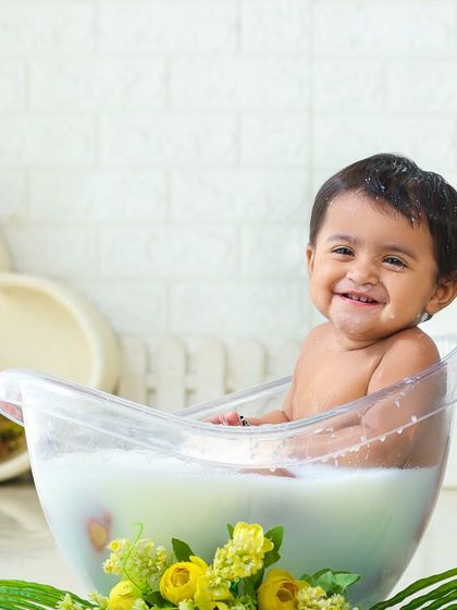 A beautiful, happy smile from the tub. The milk bath sessions are perfect for capturing those gummy, joyful baby grins.