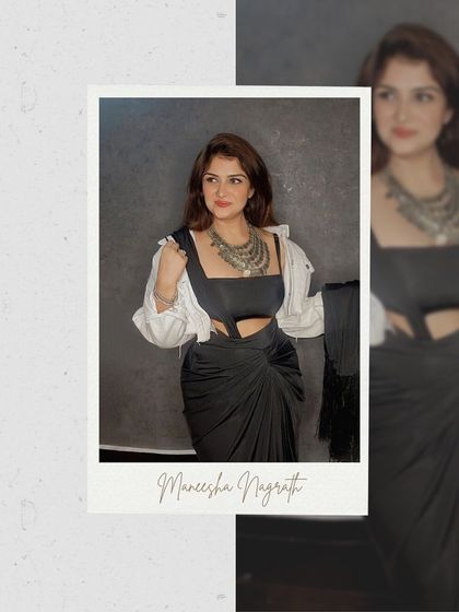 The black dress layered with a white shirt and statement necklace, transforming it into a powerful fusion look.