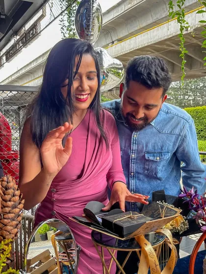 The joy of unboxing shared memories. This couple is exploring their personalized memory box, a key part of my 'Time Travel' experience that sparks conversation and happy tears.
