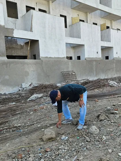 Examining the ground at a raw construction site. The energy of the land itself plays a huge role in the future well-being of its occupants.