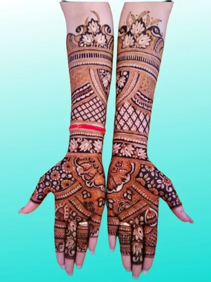 A graceful and flowing design with leafy vines and floral patterns extending up the arm, perfect for a modern yet traditional bride.