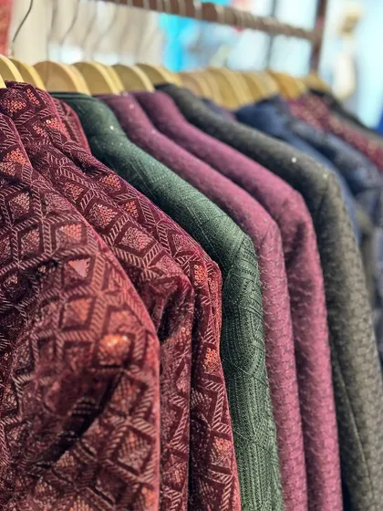 A glimpse into our collection of embellished bandhgala jackets. This rack displays a variety of rich colors like deep maroon and forest green, with detailed textures and patterns perfect for receptions and festive evenings.