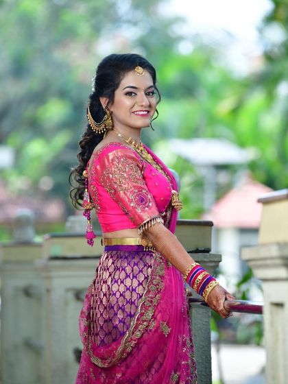 A beautiful portrait of Tanu for her engagement, showcasing her half-up, half-down hairstyle with soft curls.