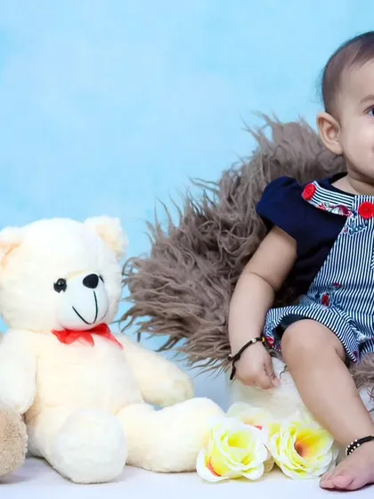 A sweet, smiling portrait of a six-month-old boy during his milestone session.