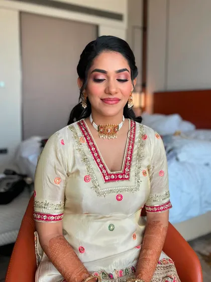 A close-up of Supriya's eye makeup. A soft wash of pink shimmer on the lids adds a festive touch without being too heavy for the daytime.