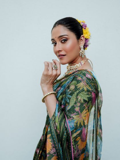 This close-up shot highlights the model's expression and the beautiful details of her jewelry and the flowers in her hair. It's a great example of a beauty-focused traditional portrait.