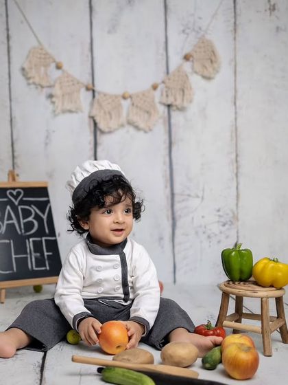 A happy moment from the baby chef photoshoot. His curly hair and bright smile make this shot extra special.