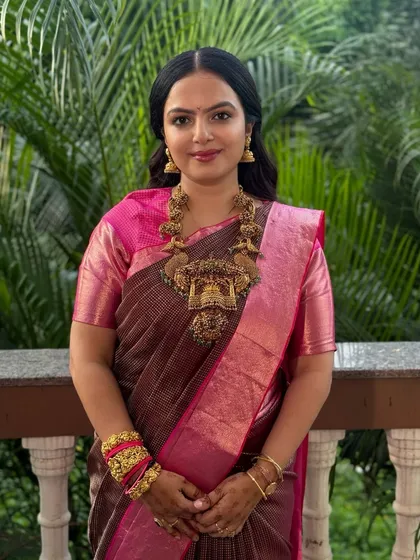 An elegant guest look for a wedding. She is wearing a beautiful silk saree, and I gave her a soft, natural makeup look with her hair styled in simple waves, adorned with roses.