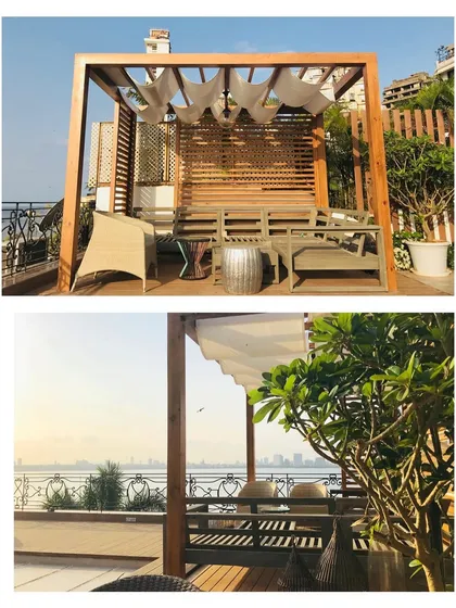 Another view from the sea facing terrace, showing the wooden pergola with a fabric canopy. This provides gentle, filtered sunlight, making the seating area comfortable even during the day.