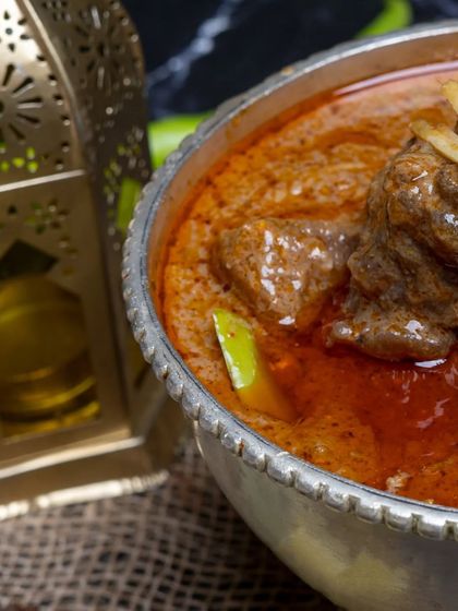 A close-up of our Nalli Nihari, showcasing the succulent bone marrow and tender meat in a deeply flavorful and aromatic stew.