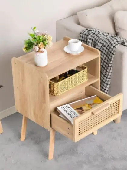 This stylish bedside table combines a light wood frame with a woven cane drawer front. It features an open shelf for display and a drawer for storage, offering a modern and functional piece for the bedroom.