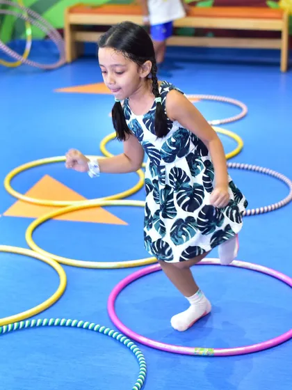 A camper participates in a hula hoop game during our summer camp. We keep kids active and engaged.