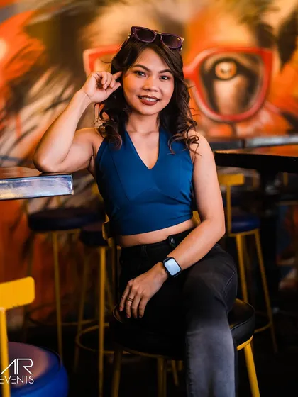 A guest posing on a bar stool.