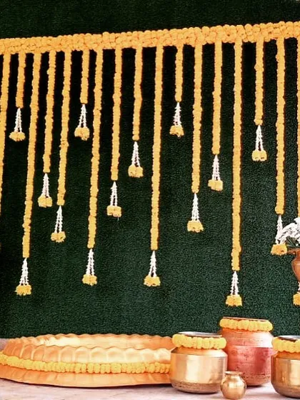 For a classic Haldi ceremony, we designed this beautiful backdrop using traditional marigold garlands and authentic brass and copper urulis, giving it a warm and auspicious feel.
