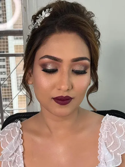 Eyes closed to showcase the stunning sparkle eye makeup. The blend of silver and black glitter creates a truly glamorous effect.