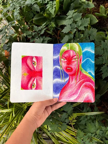A sketchbook spread with a surreal pink and green figure.