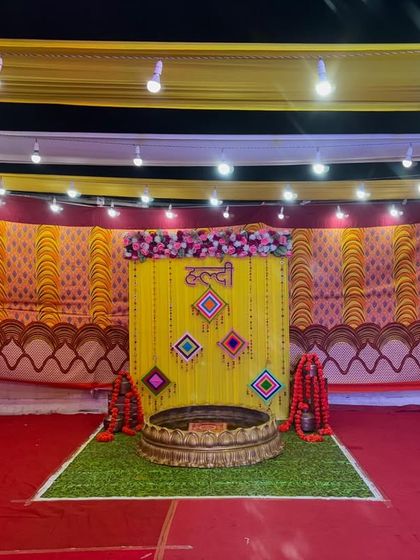 The Haldi stage illuminated by overhead lights. The setup is designed to look great both in person and in photos and videos.