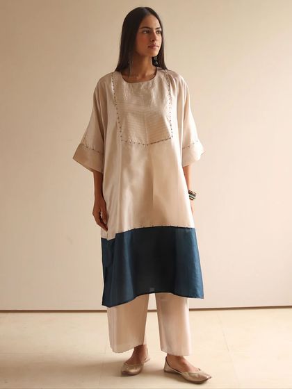 A full view of the chic color-blocked kurta and trouser set, perfect for a contemporary, understated look.