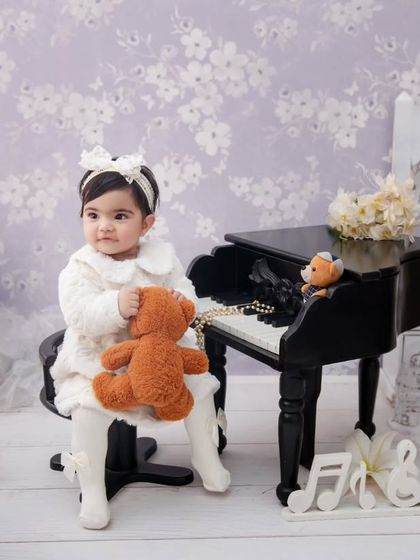 Capturing a symphony of sweetness. This little musician is celebrating her first year with a classic piano-themed shoot.