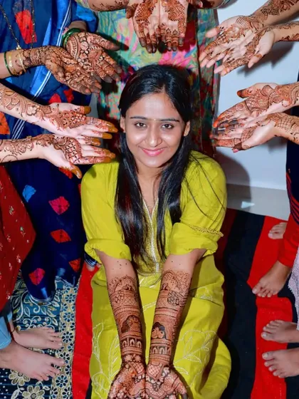 A fun group photo with the bride and her friends, all showing off their mehendi. A perfect memory from the mehendi night.