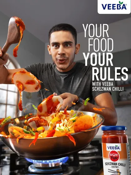 The final ad version for the Veeba Schezwan Chilli campaign, complete with the "Your Food, Your Rules" tagline. This image shows the dynamic food photography integrated into a cohesive and memorable advertisement.