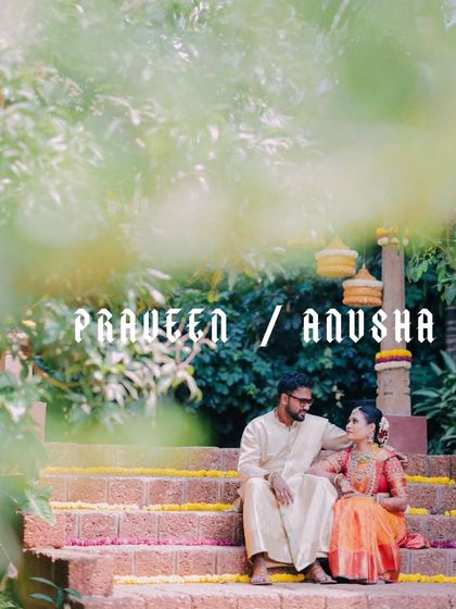 Praveen and Anusha share a quiet moment on the stone steps, framed by lush greenery. This portrait captures the serene beauty of their South Indian wedding.