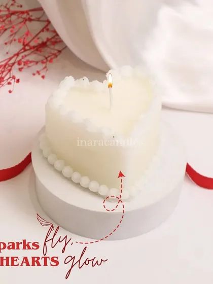 Sparks fly, hearts glow. This simple and elegant white heart-shaped candle with a pearl-like border is a classic and romantic choice for Valentine's Day.