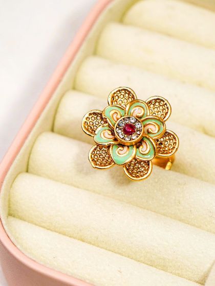 A clear, focused shot of a statement ring in its box. This angle provides a perfect view of the ring's details for an online product page.