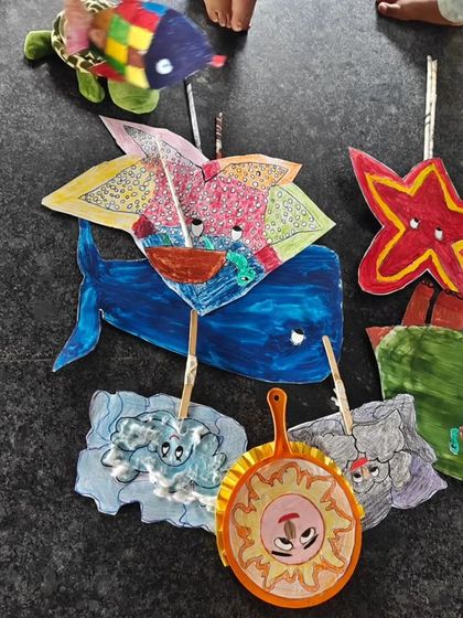 A colorful array of handmade puppets ready for the show. This image highlights the beautiful, tangible outcomes of the children's creative work.