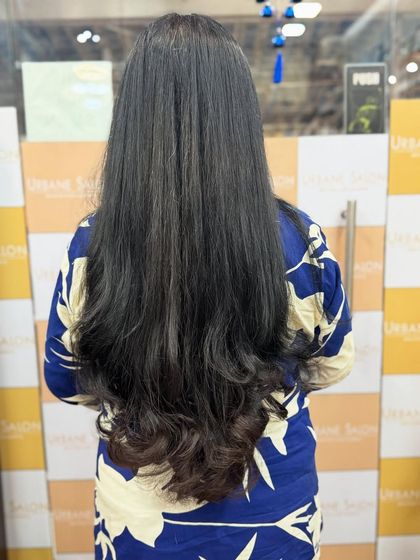 The back view of this long layered cut shows the "V" shape and the beautifully curled ends that add a touch of glamour.