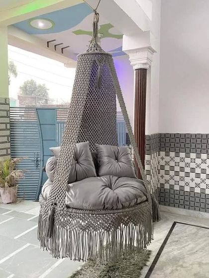 Our grey swing installed on a customer's porch. The sturdy design and comfortable cushions make it a favorite spot for the whole family.