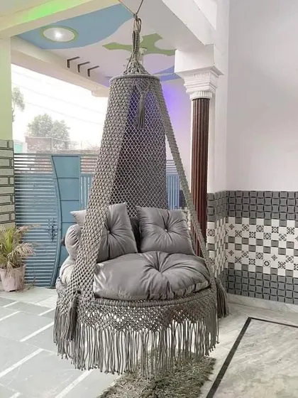 Our grey swing installed on a customer's porch. The sturdy design and comfortable cushions make it a favorite spot for the whole family.