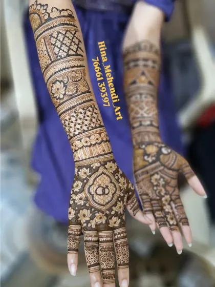An elegant engagement mehendi with a central floral mandala and interlocking rings. The arms feature a mix of jaal (net) patterns and lotus bands.