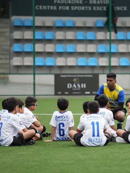 A coach's huddle with the U11s during the DPDL Super Cup. A moment of focus and strategy.