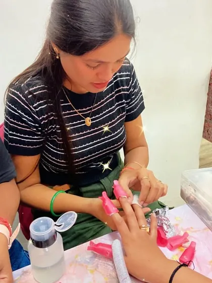 A student learns the proper technique for removing old polish and product using foils and clips, ensuring nail health.