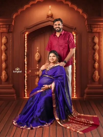 A formal seated portrait of the couple, exuding grace and happiness in their traditional outfits.