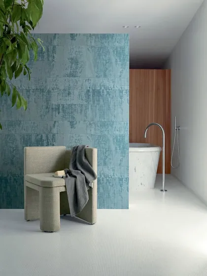 A modern bathroom featuring the "Brumes Existentielles" wallpaper in a refreshing teal hue. This demonstrates the versatility of our vinyl-effect raffia wallcoverings, which bring bold color and texture to any space, including bathrooms.