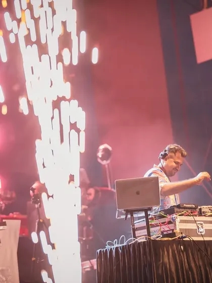 In the zone, mixing live with pyrotechnics firing up the stage. This shot captures the intensity and focus I bring to every performance, ensuring a seamless and powerful audio experience for massive concert audiences.
