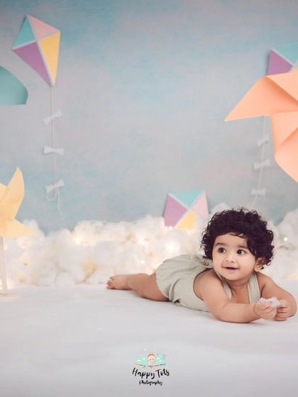 A dreamy, whimsical setup with pastel pinwheels and soft clouds. This is one of our most loved themes for capturing sweet, gentle moments.
