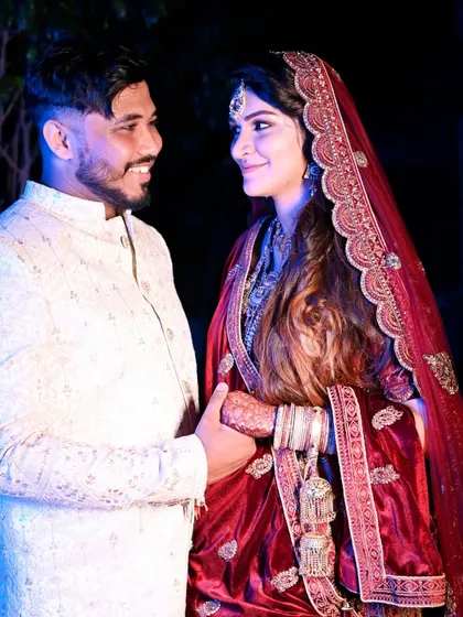 The look of love is universal. This candid shot captures a sweet, unposed moment between the bride and groom, their smiles reflecting their happiness.