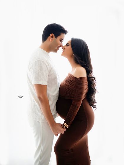 A playful and loving nose-to-nose moment. The high-key lighting gives this boho-style shot a bright and airy feel.