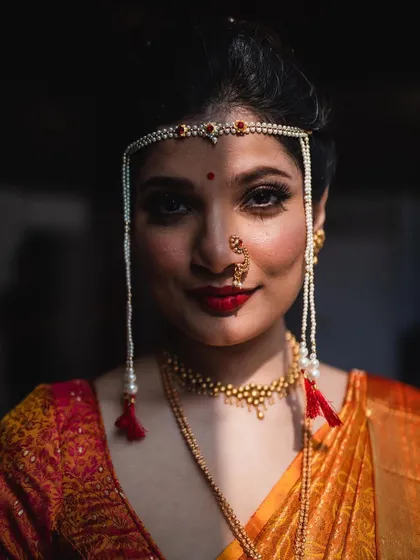 Another striking portrait of the Maharashtrian bride. The play of light and shadow across her face adds depth and drama to the image.