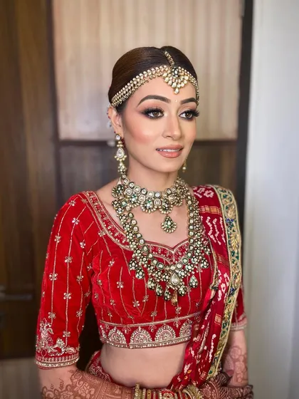 A profile shot highlighting the intricate details of the eye makeup and the smooth, long-lasting finish of Bhavika's bridal look.
